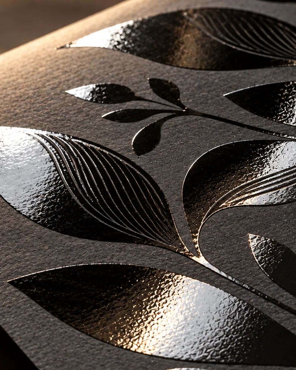 Business cards with a selective gloss coating over a dark matte surface